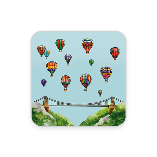 Coaster with hot air balloons and a bridge design on a light blue background
