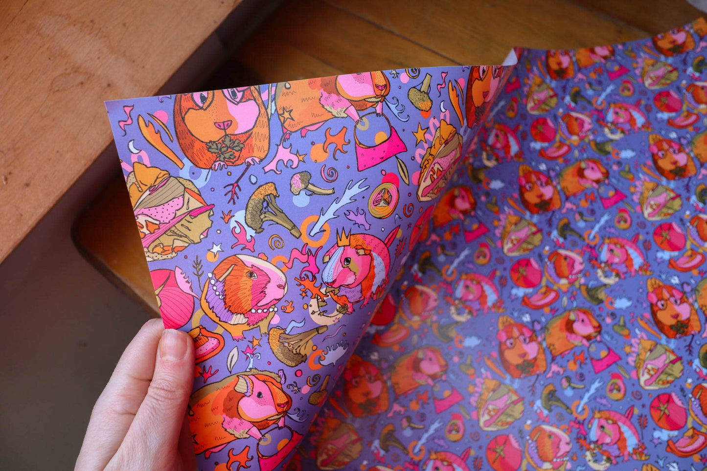 Colourful wrapping paper with guinea pigs wearing crowns.