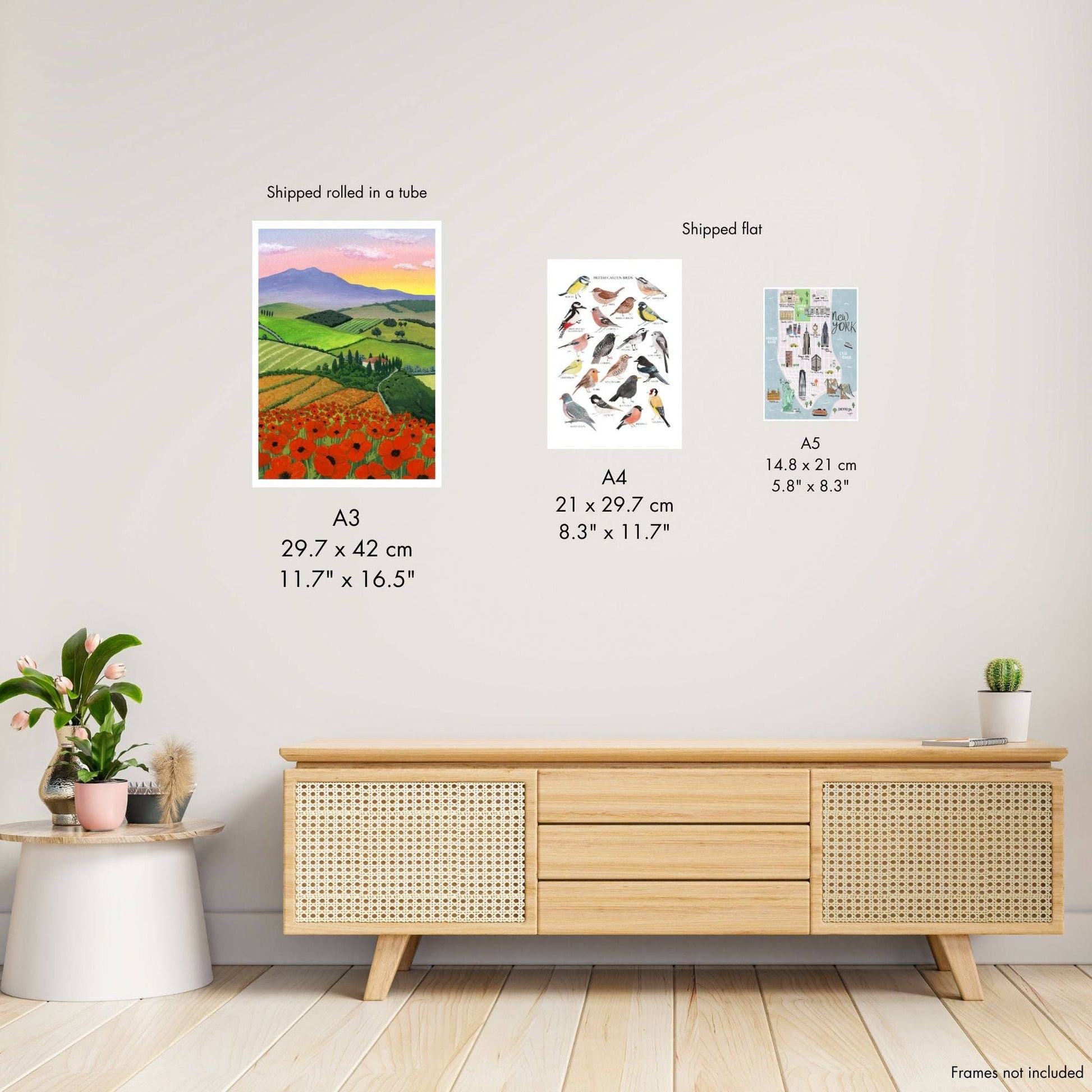 Wooden sideboard with wall art prints and size information on a white wall.