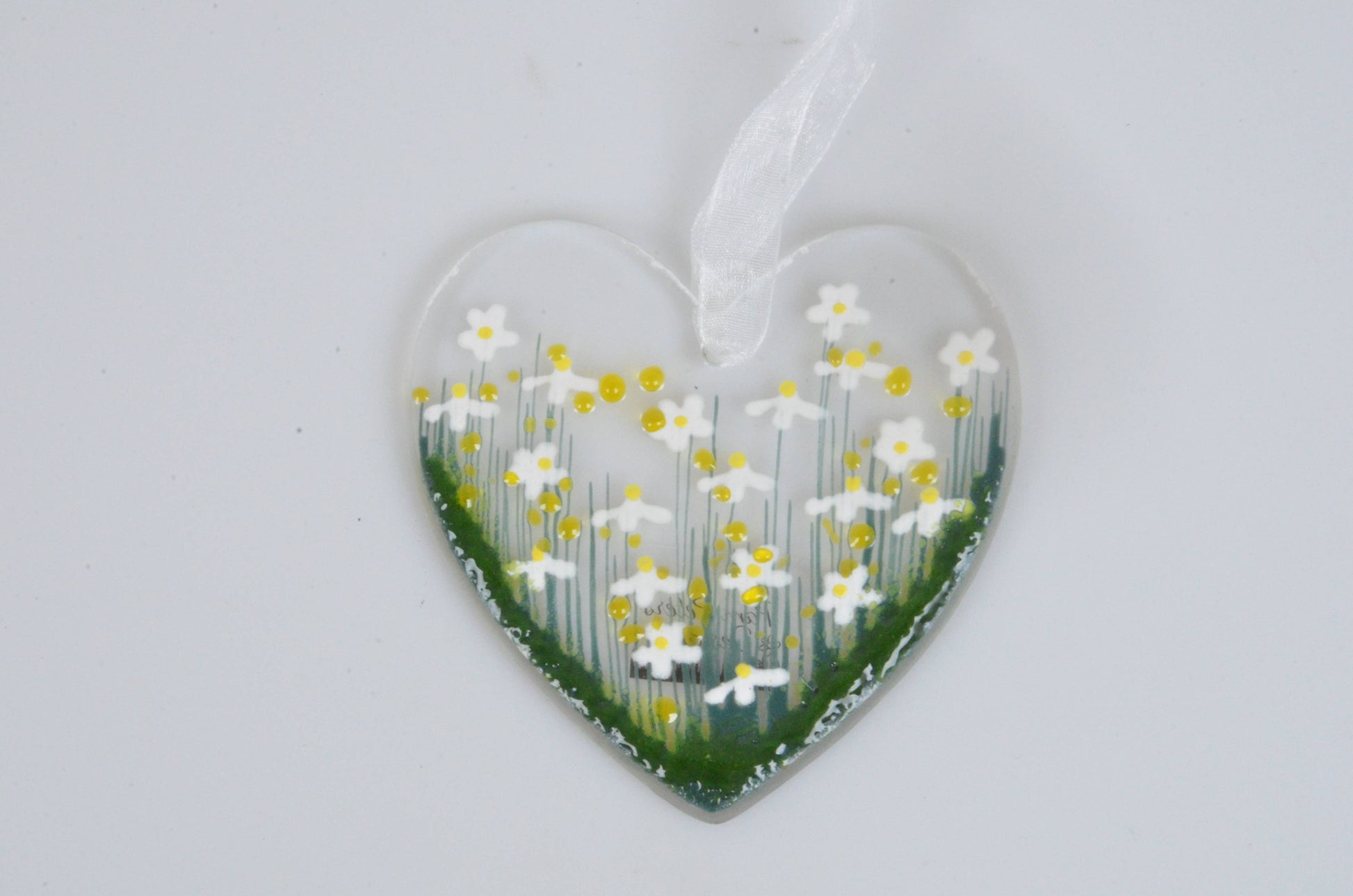 Heart-shaped ornament with floral design on a white background
