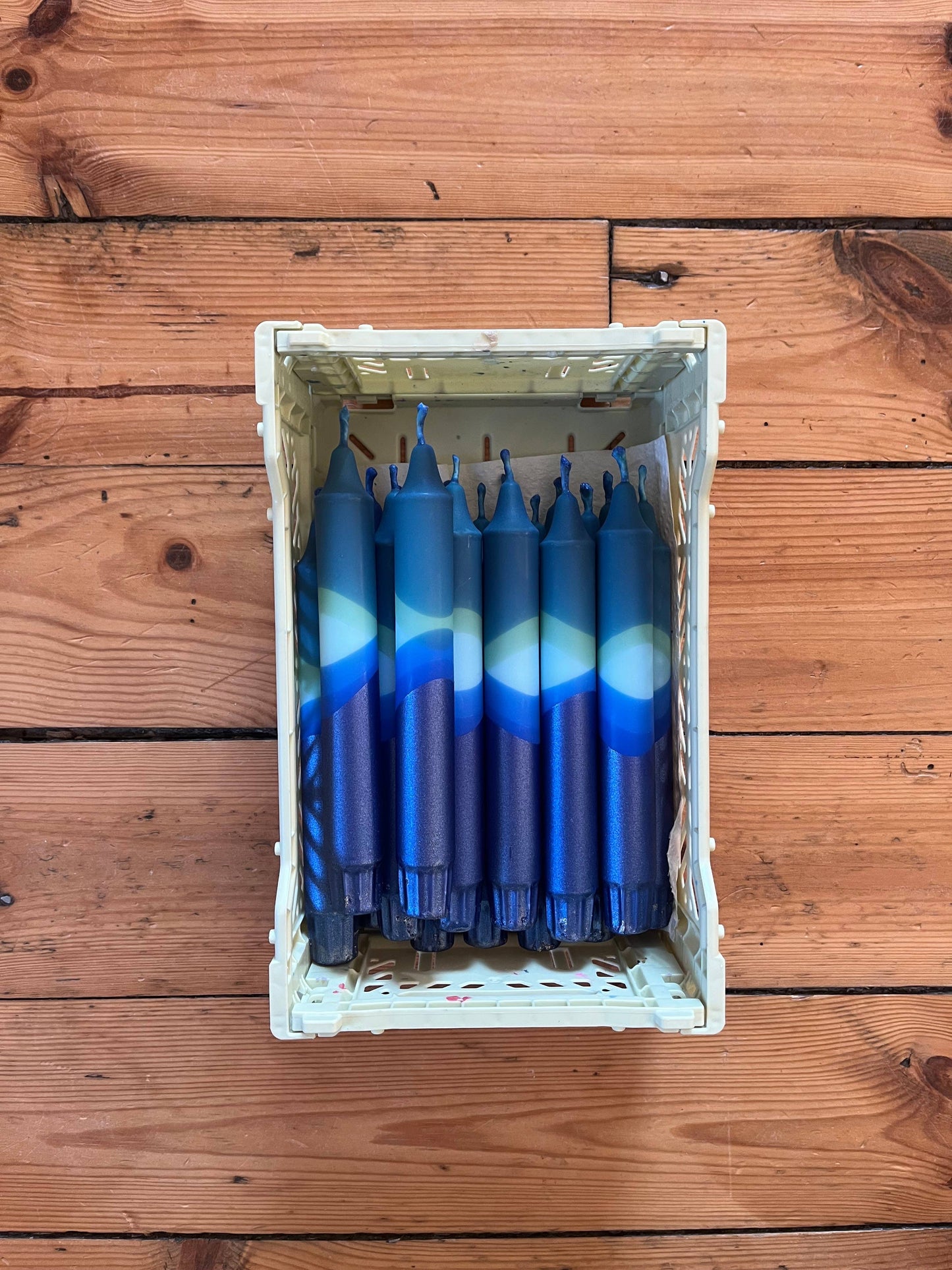 Box of blue and white candles on a wooden surface
