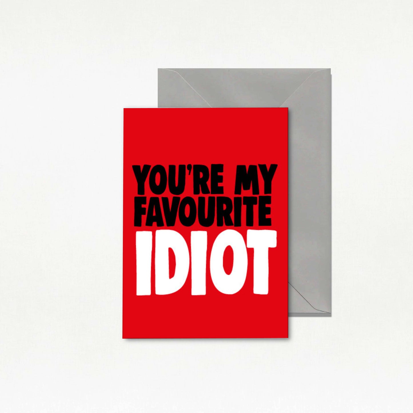 Red card with text 'You're my favourite idiot' and a gray envelope on a white background
