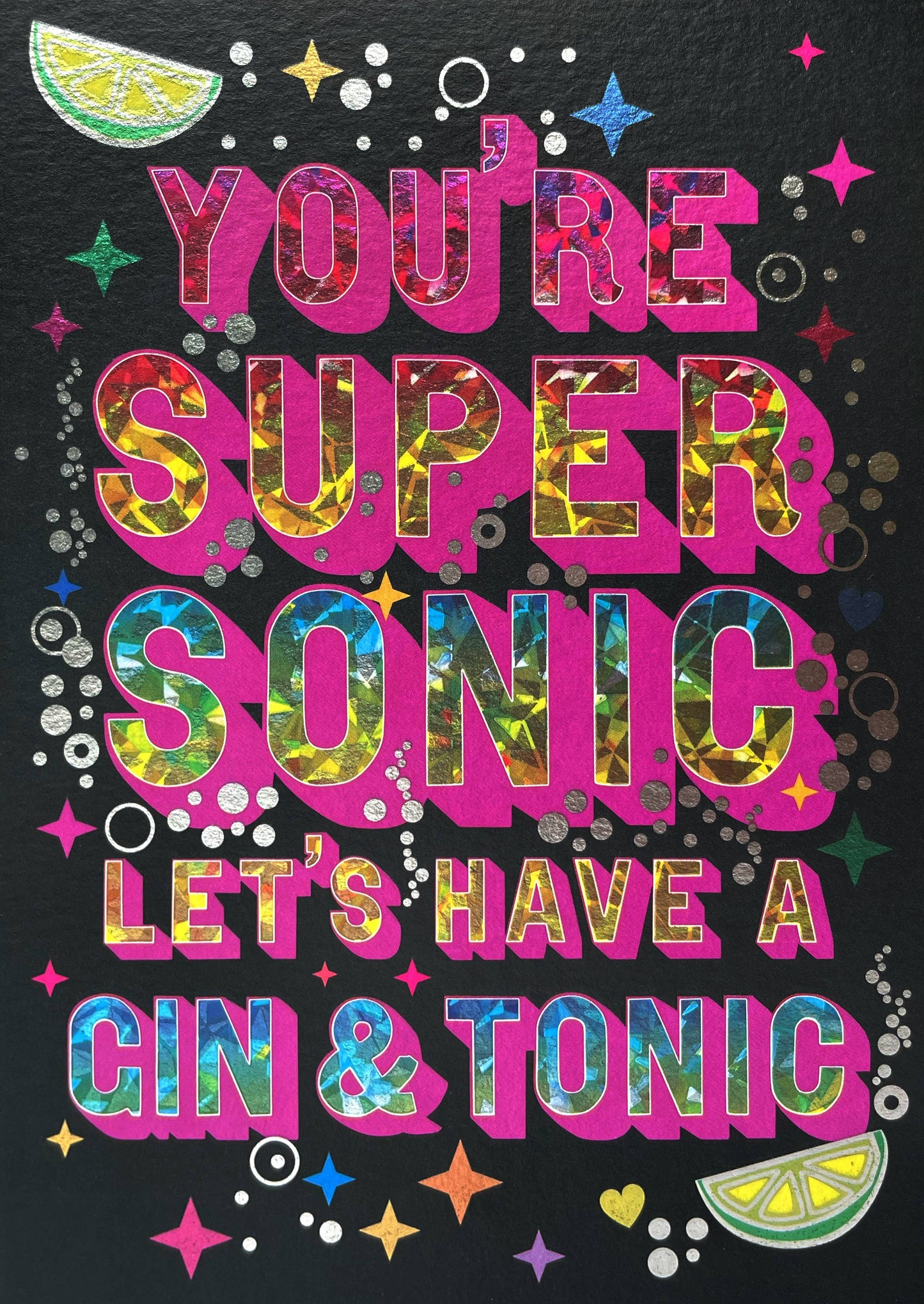 A card with the phrase "You're supersonic let's have a gin & tonic" in a sparkly font surrounded by bubbles, limes and sparkles.