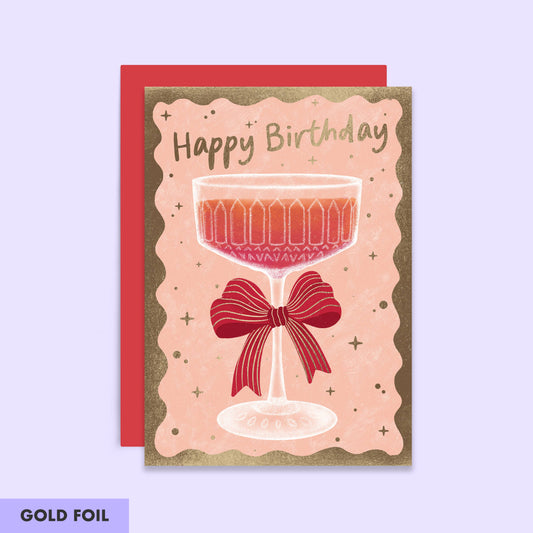 Birthday Card with a champagne coup with a bow attached.