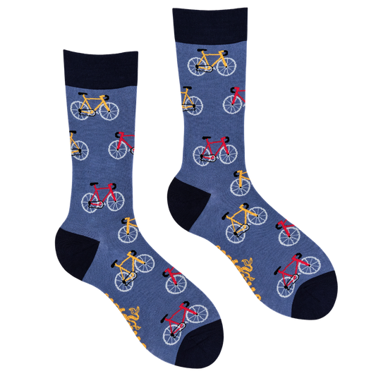 A pair of crew socks in heathered blue with a repeating pattern of bicycles in yellow, red, and white, finished with solid black cuffs, heels, and toes.