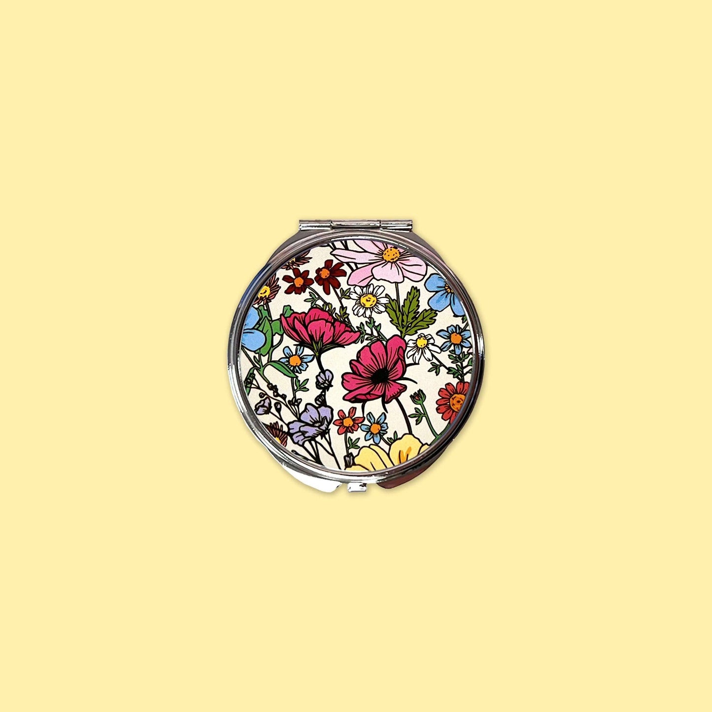 Small mirror compact with pretty floral design.