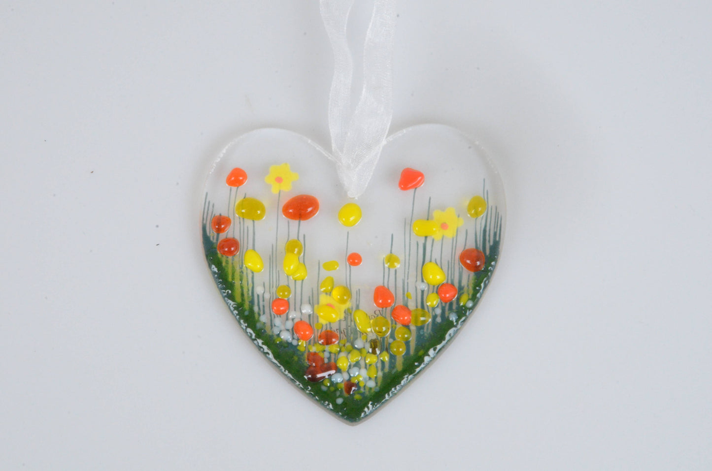 Heart-shaped ornament with floral design on a white background