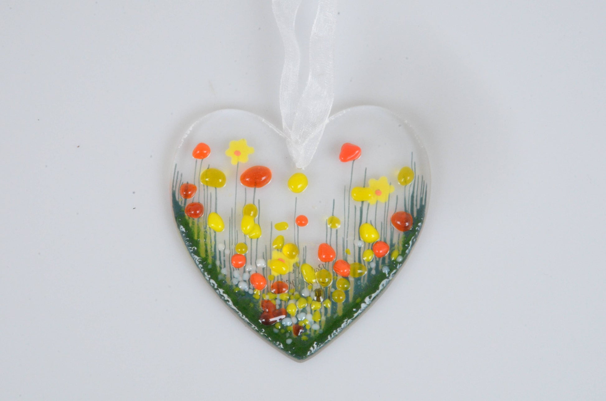 Heart-shaped ornament with floral design on a white background