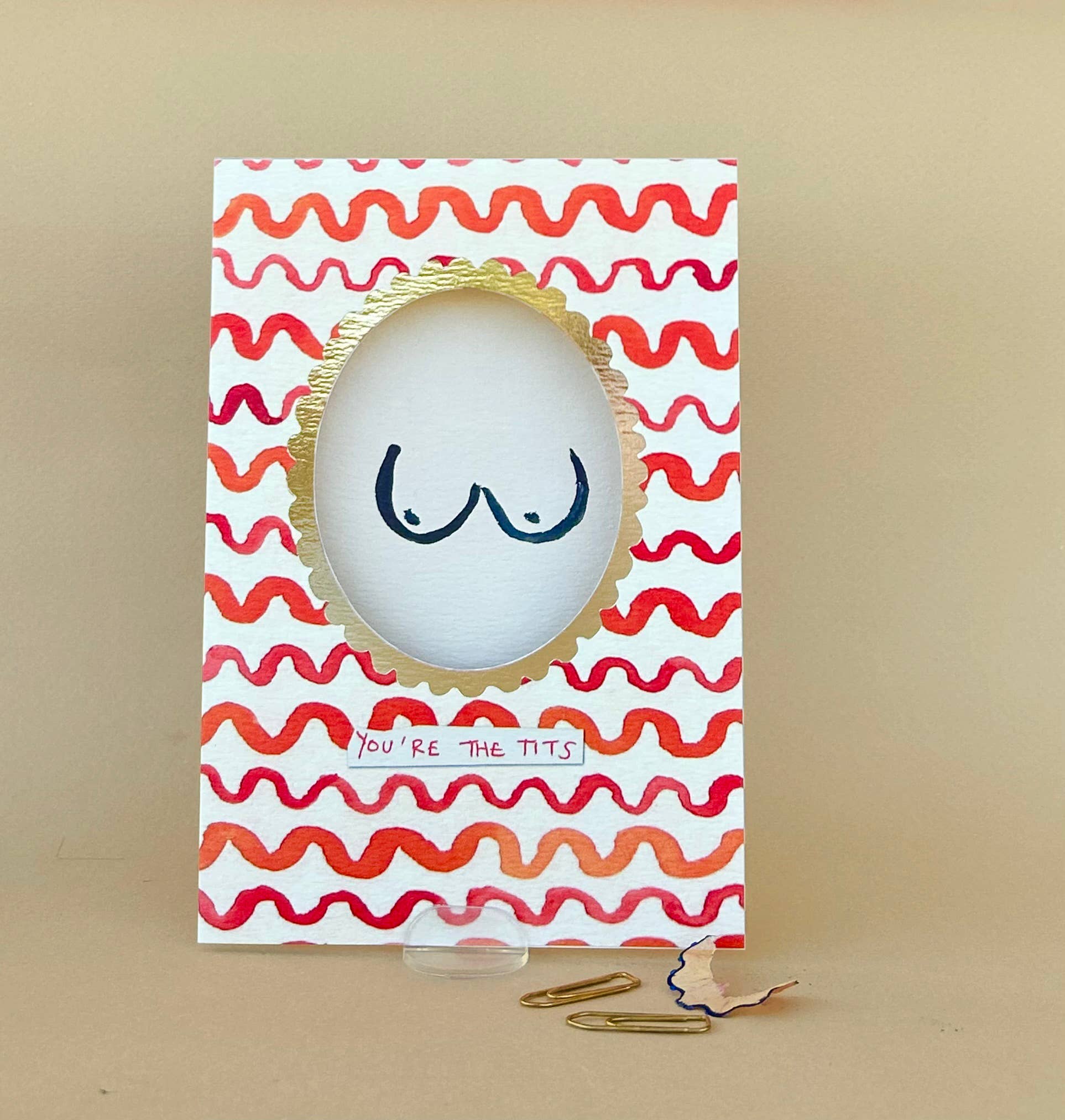 You're the tits card, drawn tits on inside of card with an oval gold cut out frame.