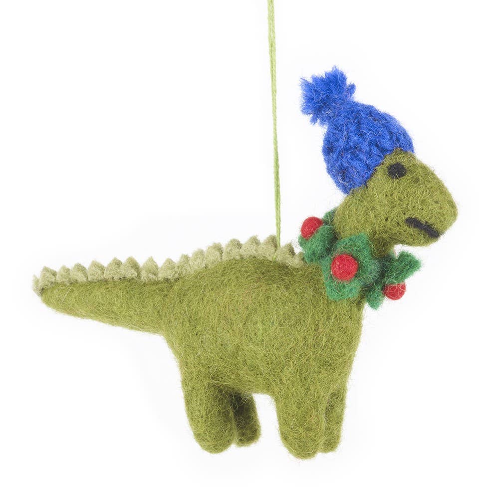 Felted dinosaur ornament with a blue hat and holly wreath on a white background