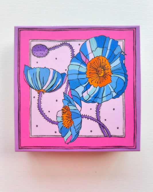 Matches in a beautifully illustrated blue box with blue poppies and a pink background.