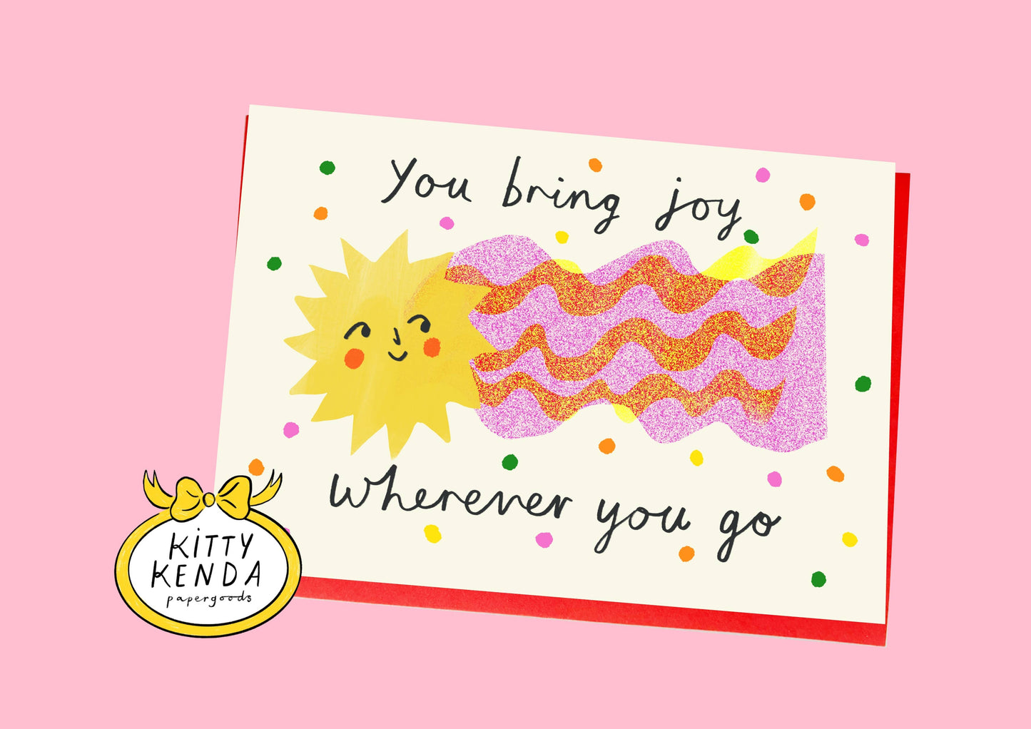 Card with sun illustration and text 'You bring joy wherever you go' on a pink background, featuring the Kitty Kenda logo.