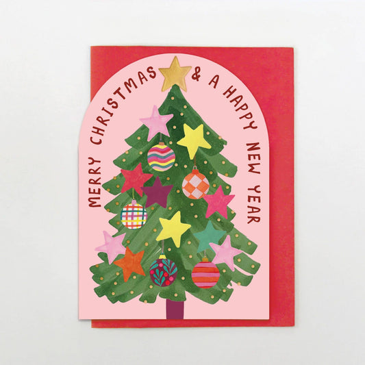 Christmas card with a decorated tree and colorful ornaments on a pink background