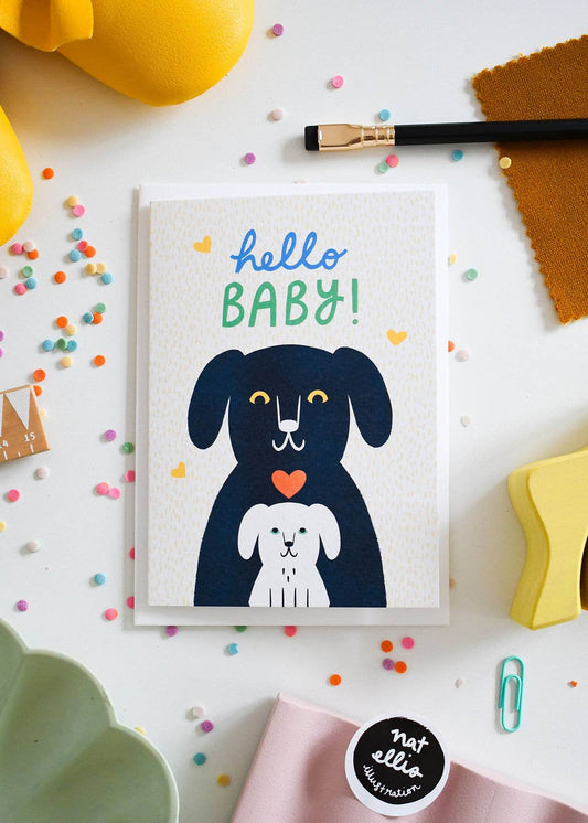 Greeting card with a dog illustration and 'hello BABY!' text on a colorful background.