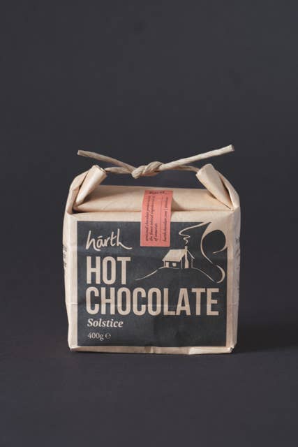 Box of hot chocolate with a rustic design on a dark background