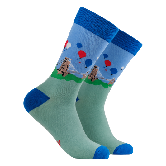 Pair of socks with a design of a bridge and balloons on a white background