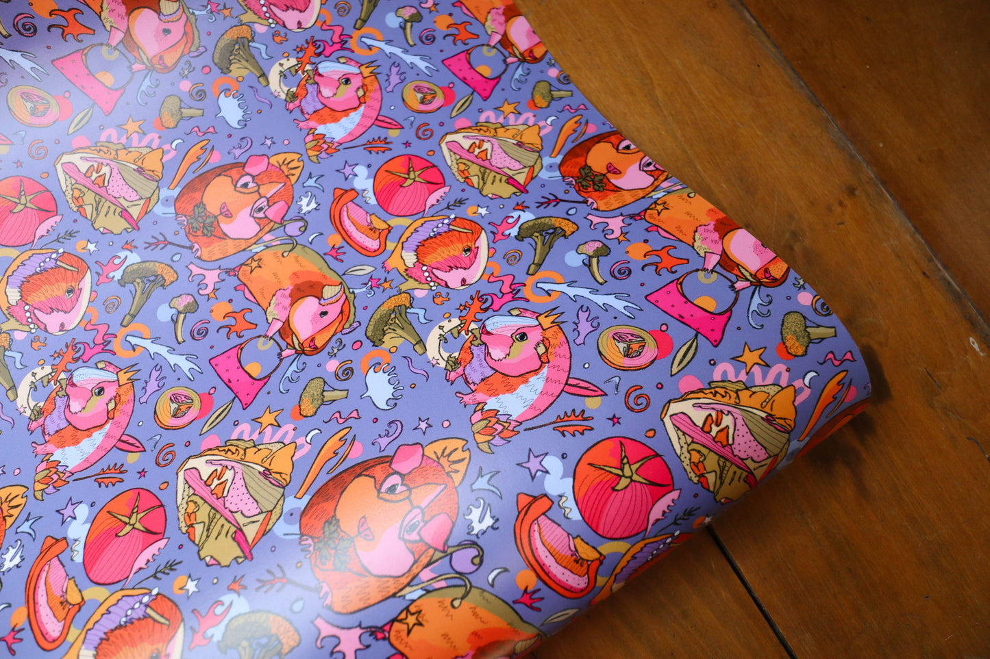 Colourful wrapping paper with guinea pigs wearing crowns.