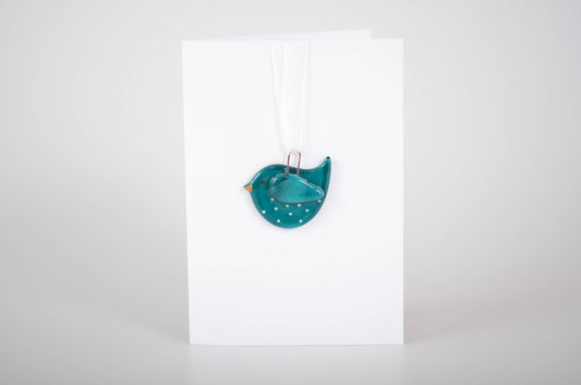 Teal bird-shaped object on a white background