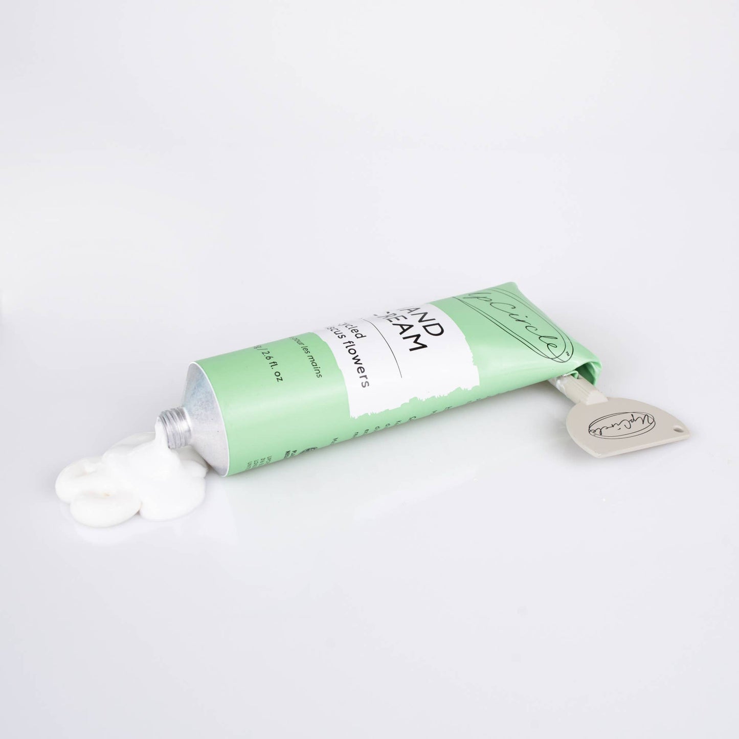 Green tube of cream on a white background