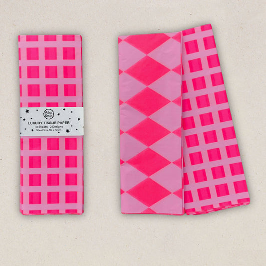Two packages of pink and white patterned tissue paper on a beige background