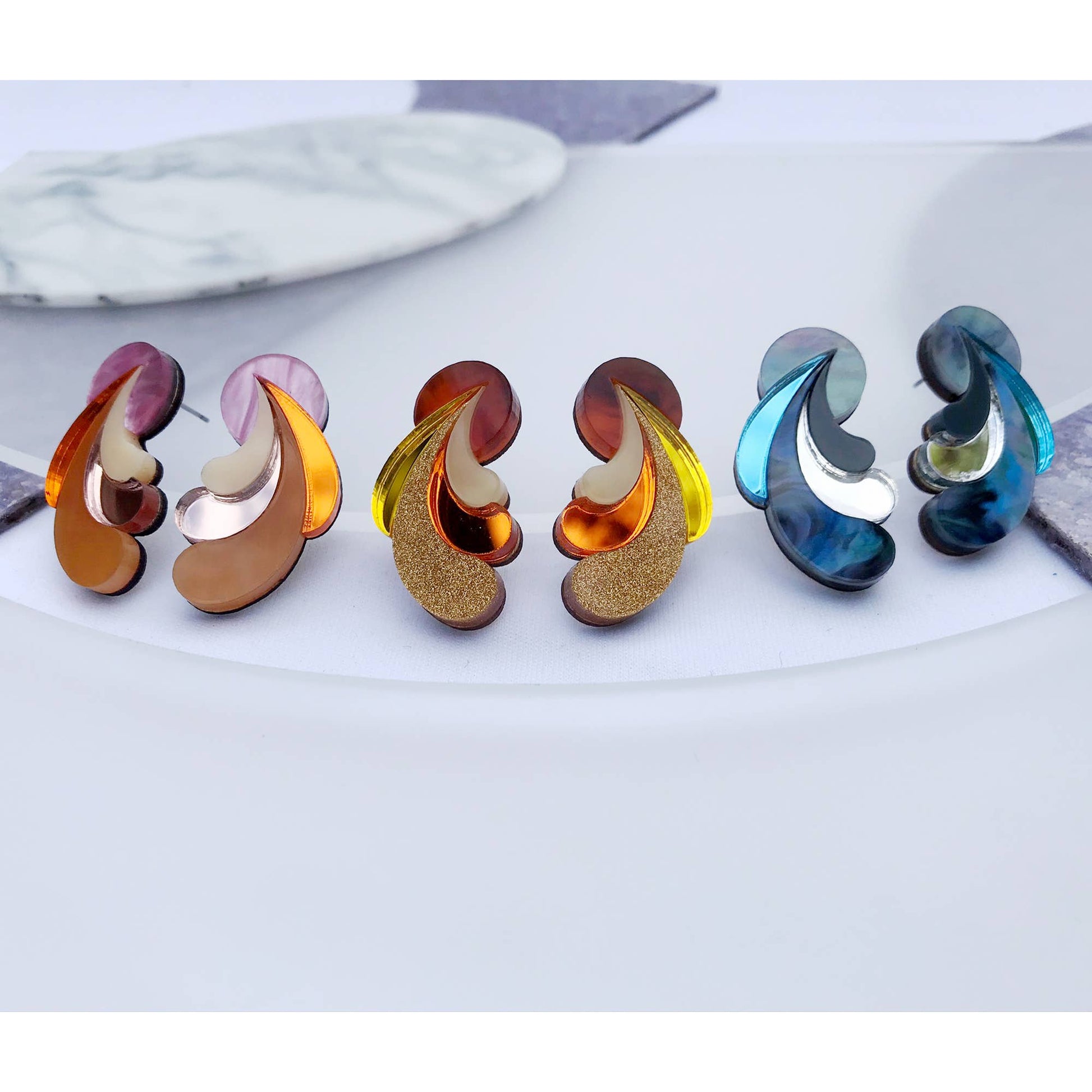 Colorful earrings on a marble surface