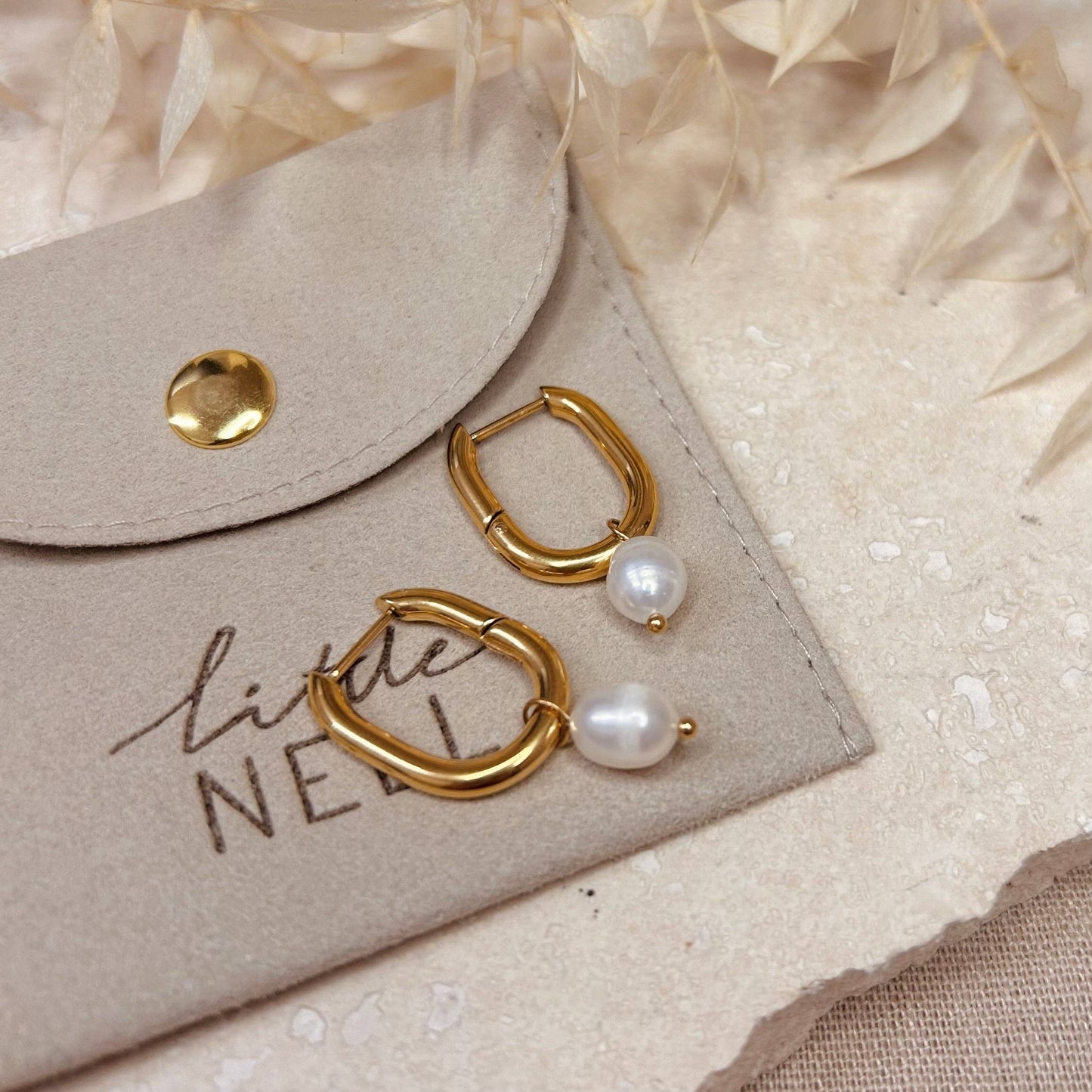 Gold plated hoop with detachable pearl charm.
