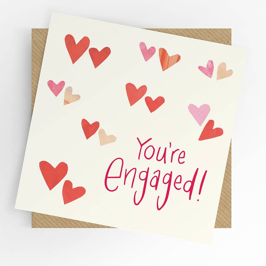 Card with 'You're Engaged!' text and colorful hearts on a white background