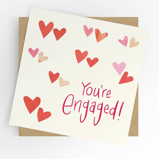Card with 'You're Engaged!' text and colorful hearts on a white background