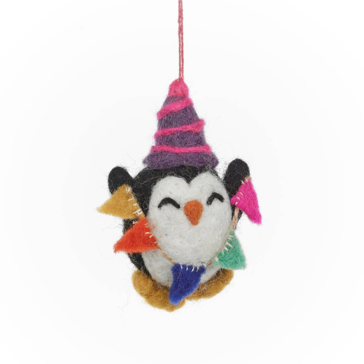 Felted penguin ornament with colorful hat and scarf on a white background