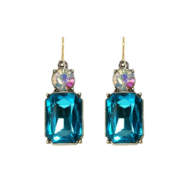 Pair of earrings with blue gemstones and multicolored centers on a white background