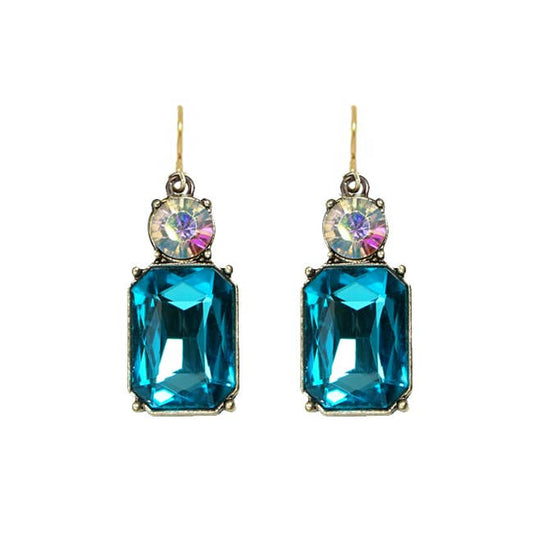 Pair of earrings with blue gemstones and multicolored centers on a white background