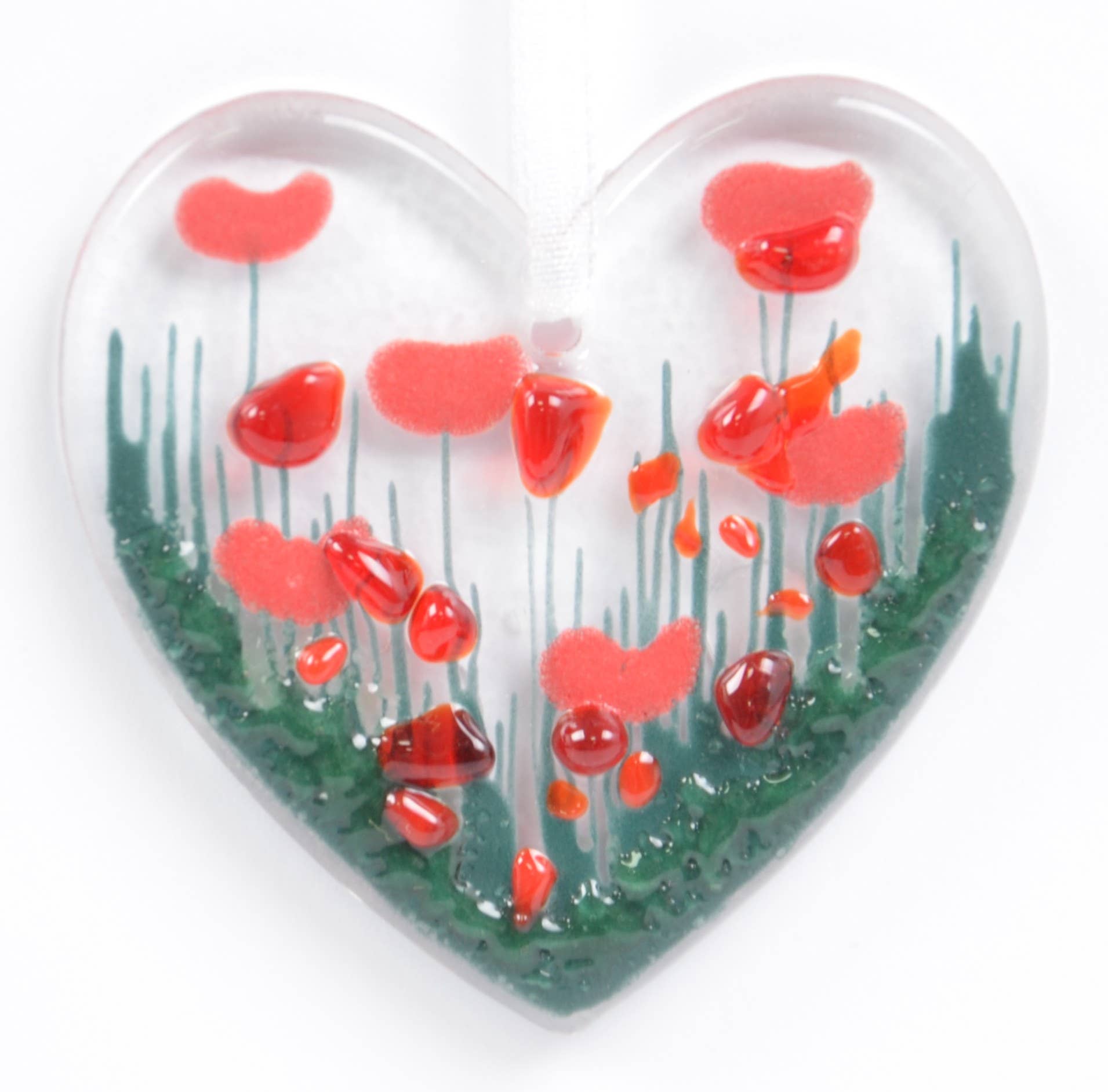 Heart-shaped object with red floral design on a white background