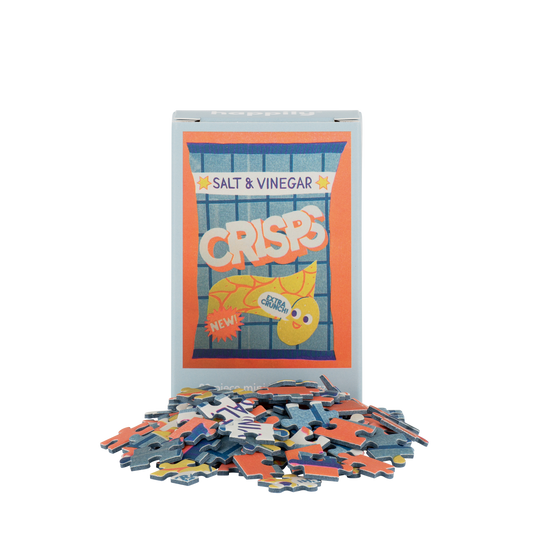 Puzzle with pieces scattered around, featuring a Salt & Vinegar Crisps packaging design.