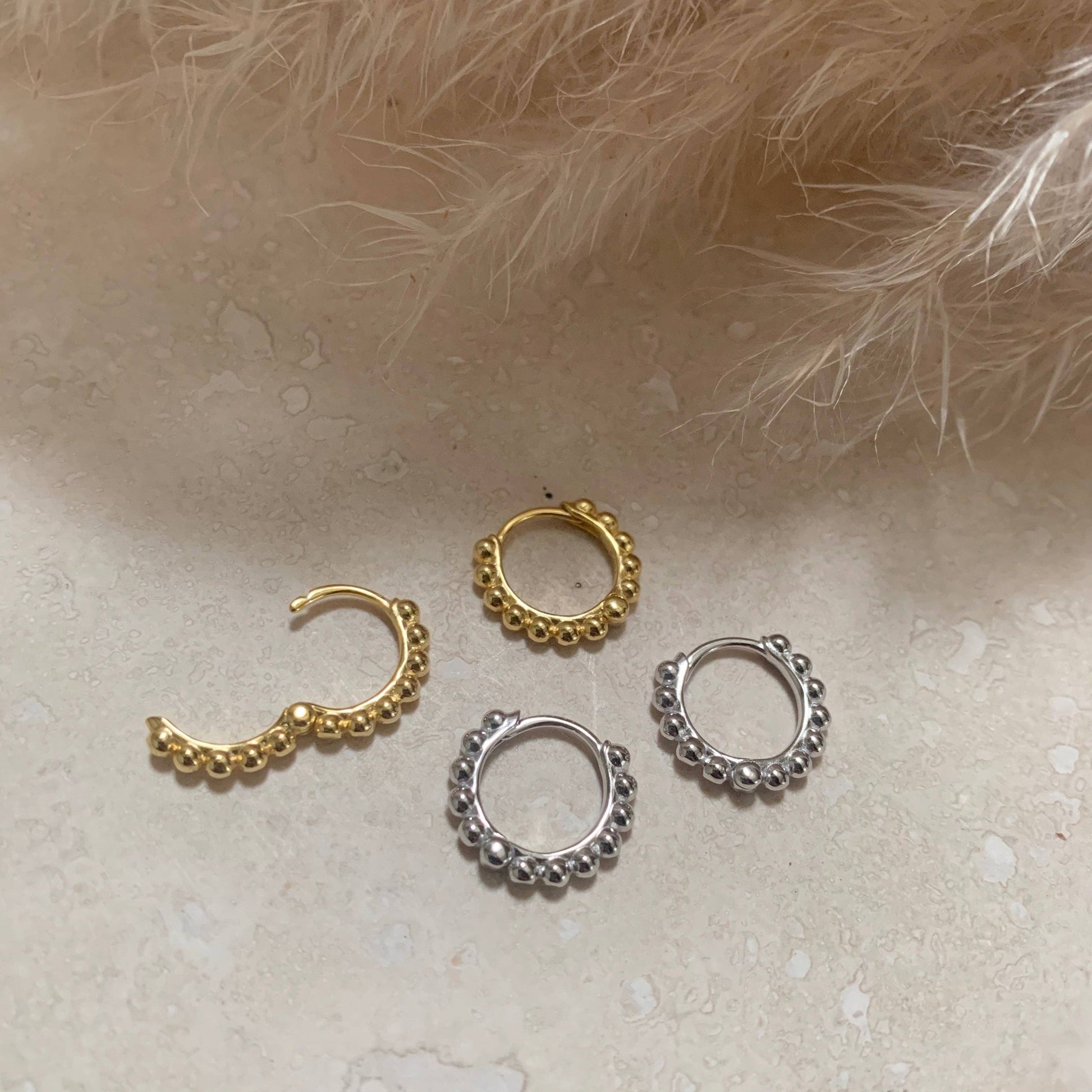 Small hinged hoops available in gold or silver.