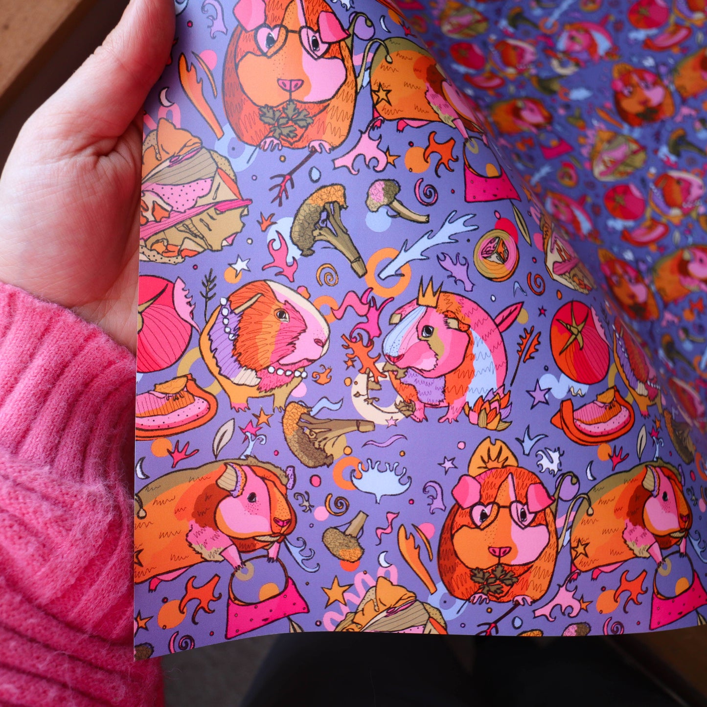 Colourful wrapping paper with guinea pigs wearing crowns.