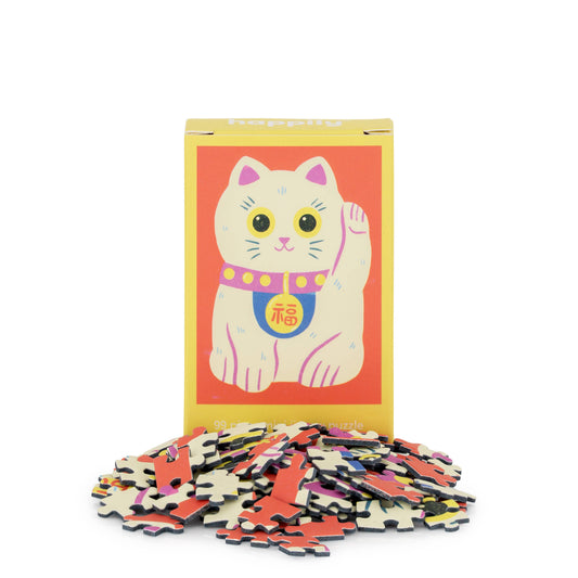 Cat-themed puzzle with colorful pieces and a box featuring a cat illustration on a white background