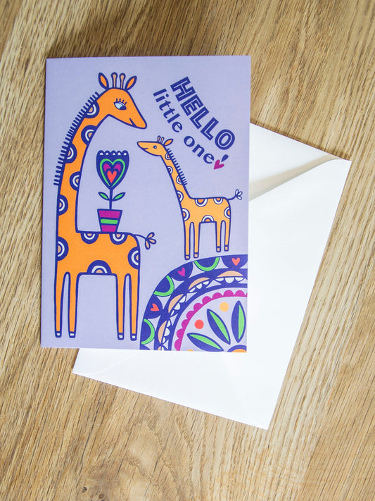 A Lilac card with an adult and baby giraffe smiling and facing each other. The card reads "Hello little one!"