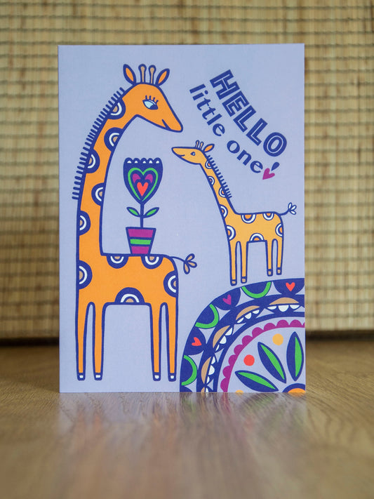 A Lilac card with an adult and baby giraffe smiling and facing each other. The card reads "Hello little one!"