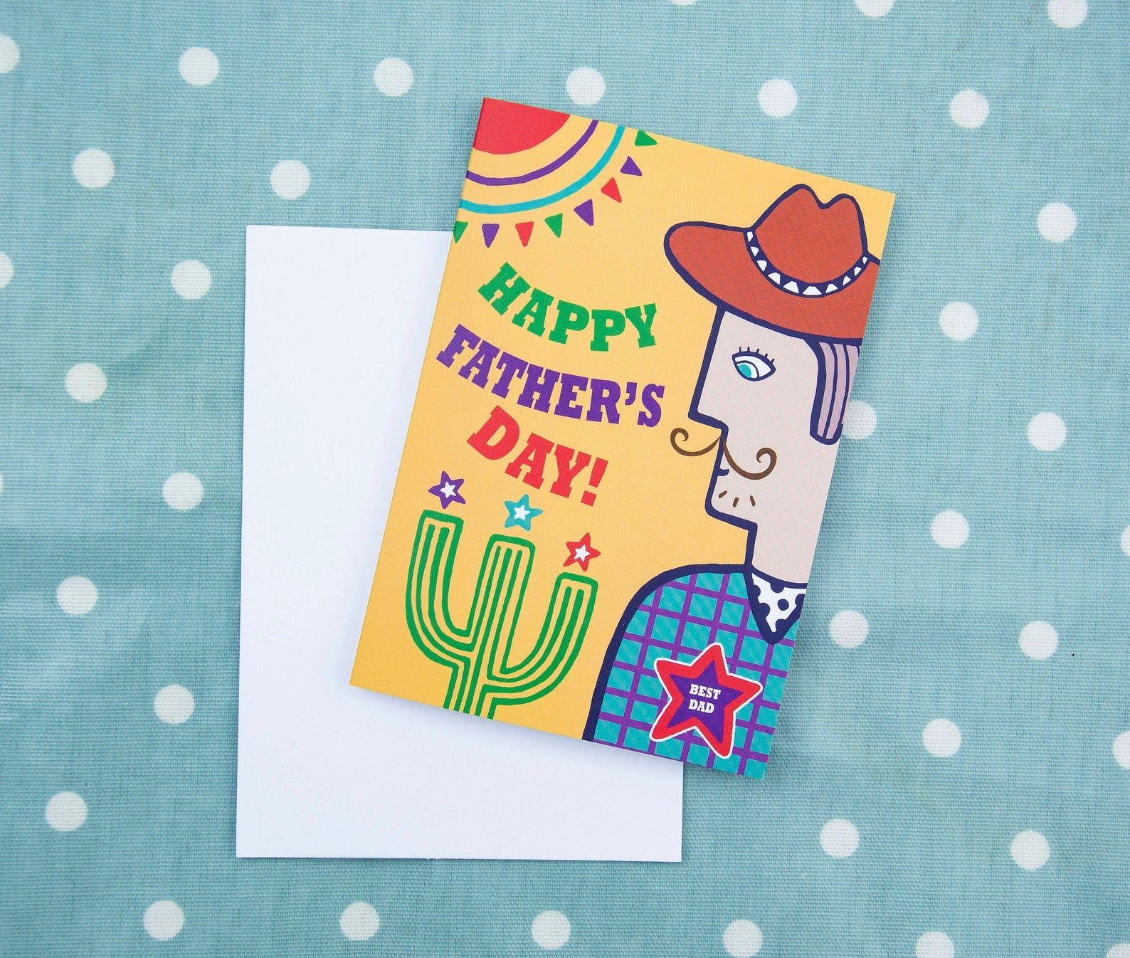 A yellow card with a side view portrait of a cowboy wearing a star badge that reads "Best Dad". To the left of the cowboy is the text "Happy Father's Day!"