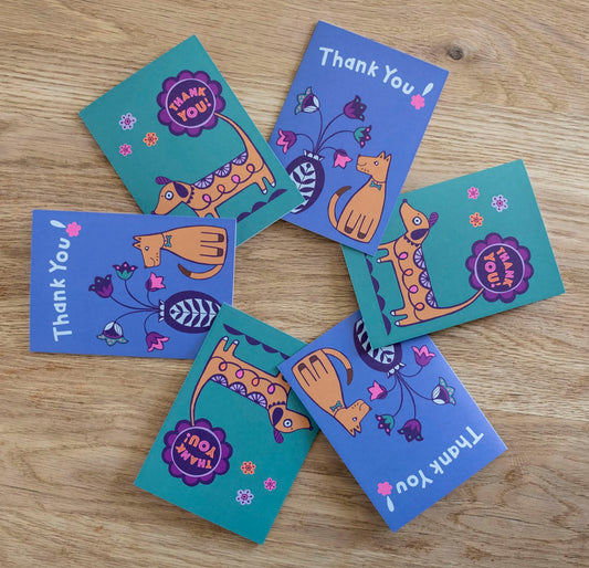 A set of 6 dog themed thank you cards, showcasing 2 different designs both featuring a brown dog and the phrase "Thank You!".
