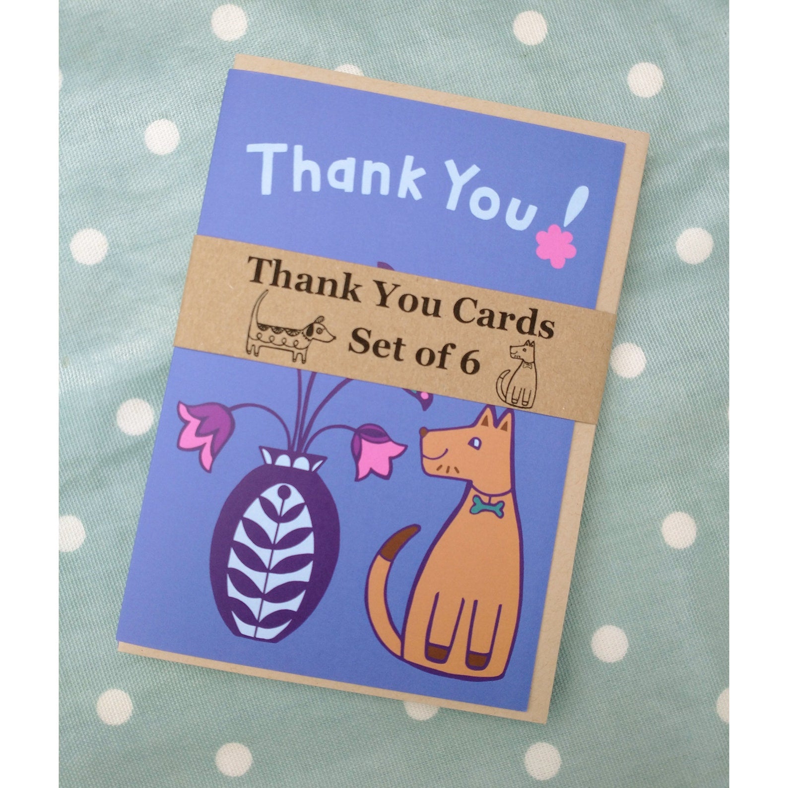 A set of 6 dog themed thank you cards wrapped with a brown paper band.