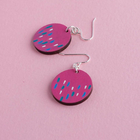 Pink circle dangly earrings with blue and white dash pattern