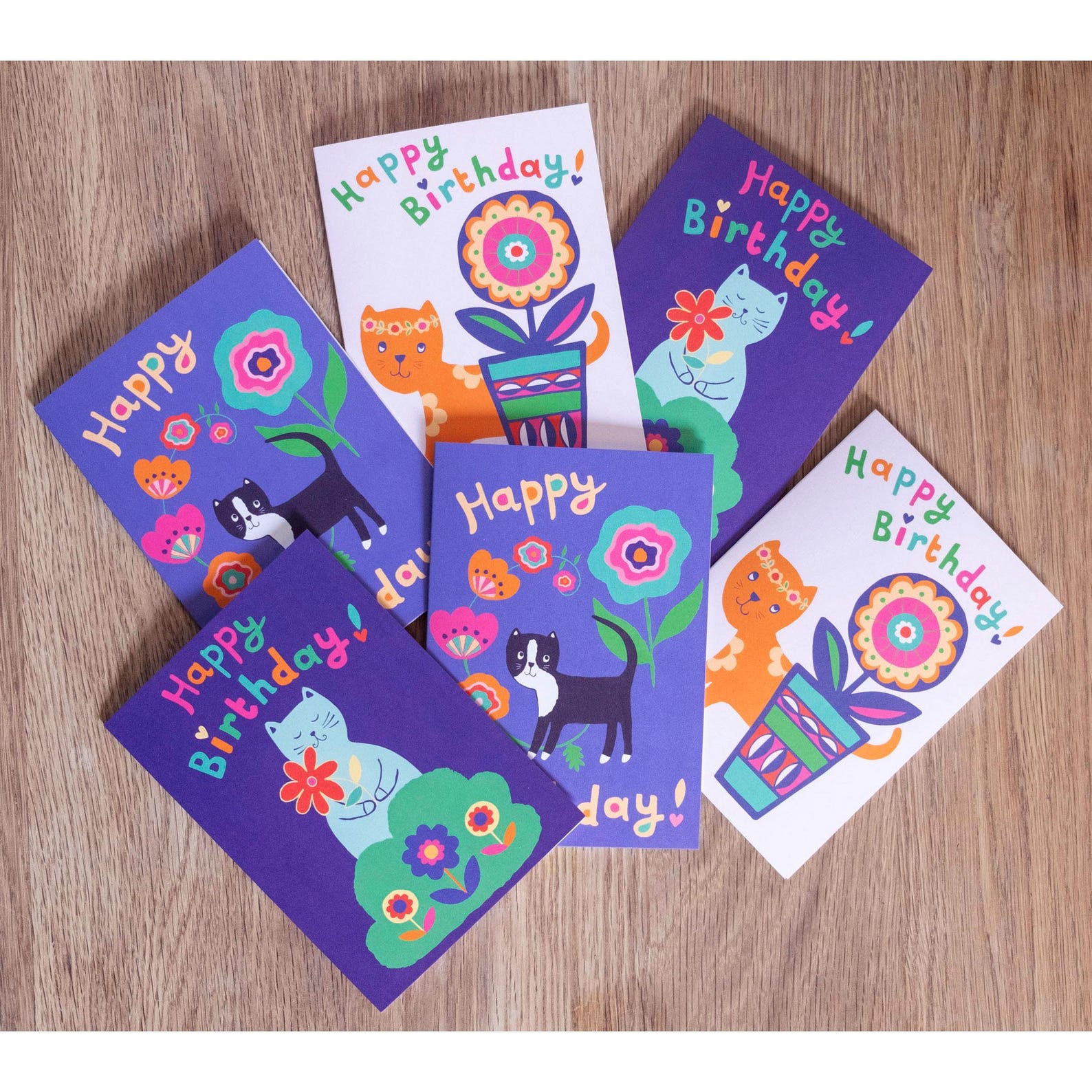 A set of 6 cat and flower themed birthday cards.