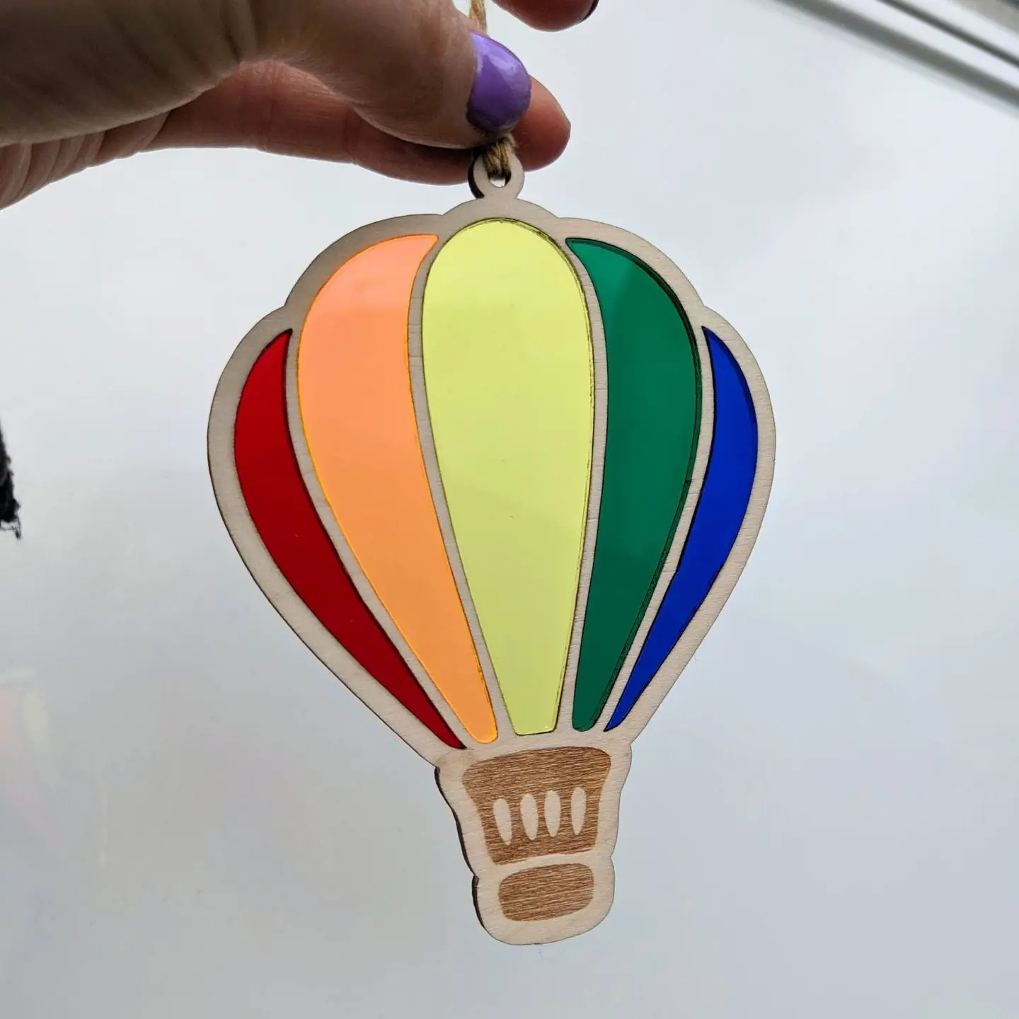 Laser cut balloon with 5 different acrylic colours to create a rainbow hanging