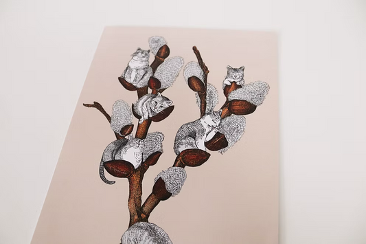 Decorative wall art with stylized animals on a branch against a beige background