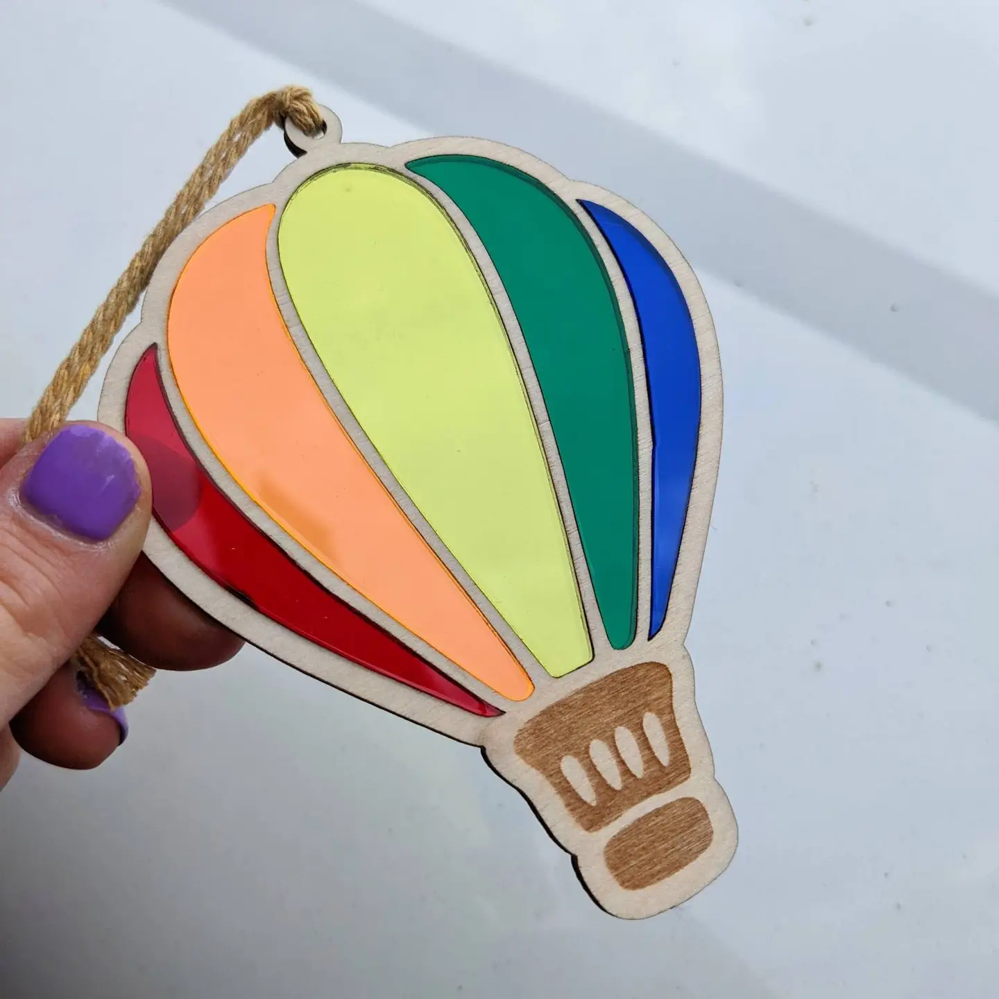 Laser cut balloon with 5 different acrylic colours to create a rainbow hanging