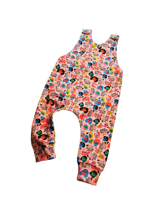 Vibrant colours print has women's faces and enpowering slogans all over.  Poppers on the shoulders.