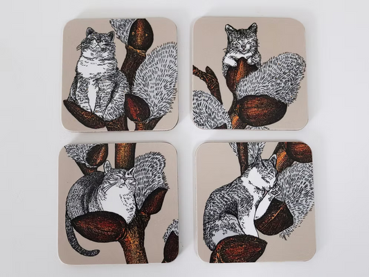 Set of four coasters with cat illustrations on a beige background