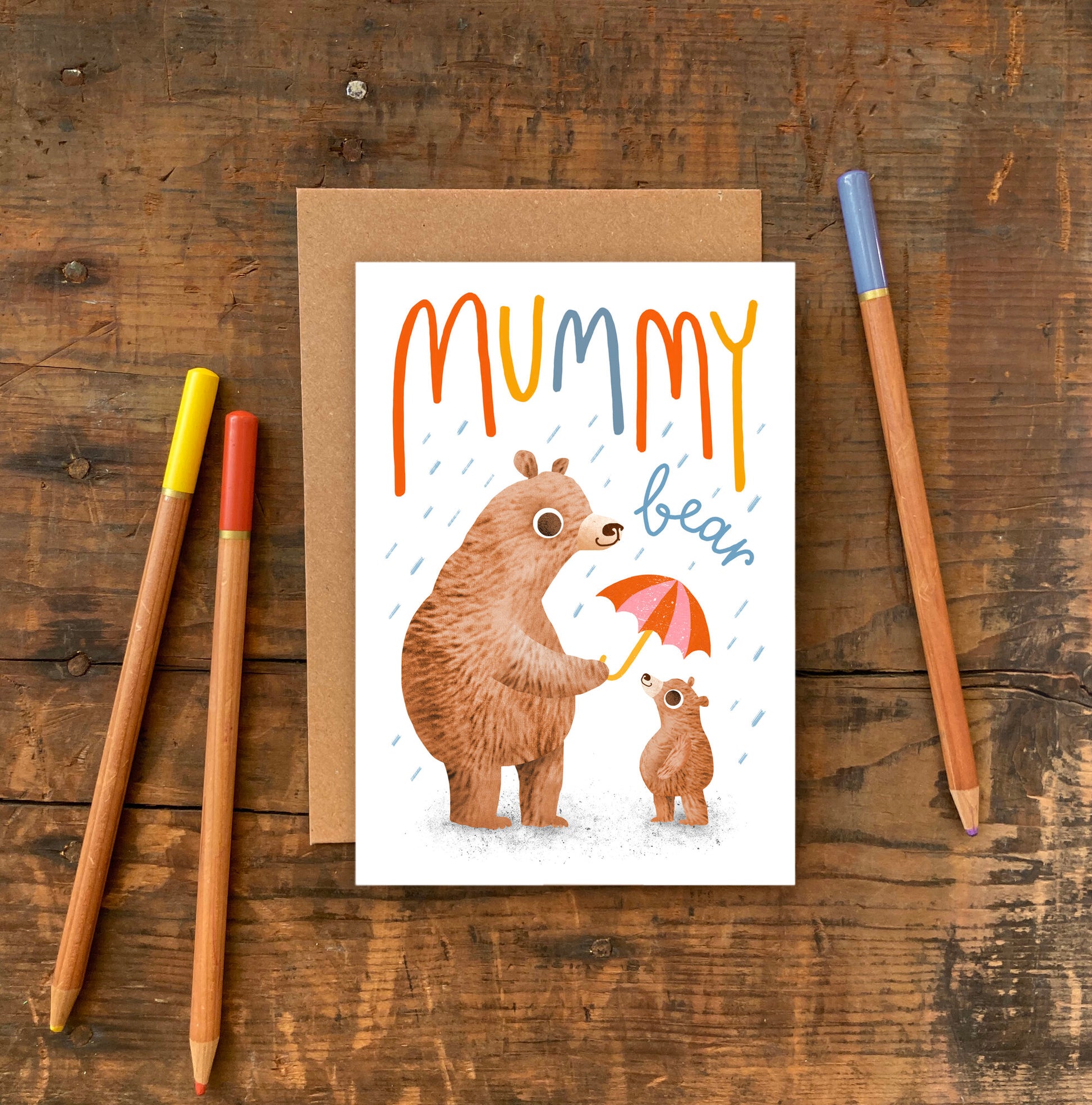 A mummy bear holding an umbrella over a baby bear illustration . A cute mothers day card.