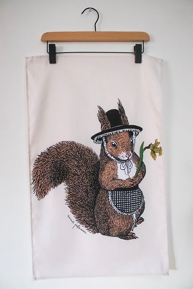 Tea towel with a squirrel wearing a top hat and bow tie design on a white background.